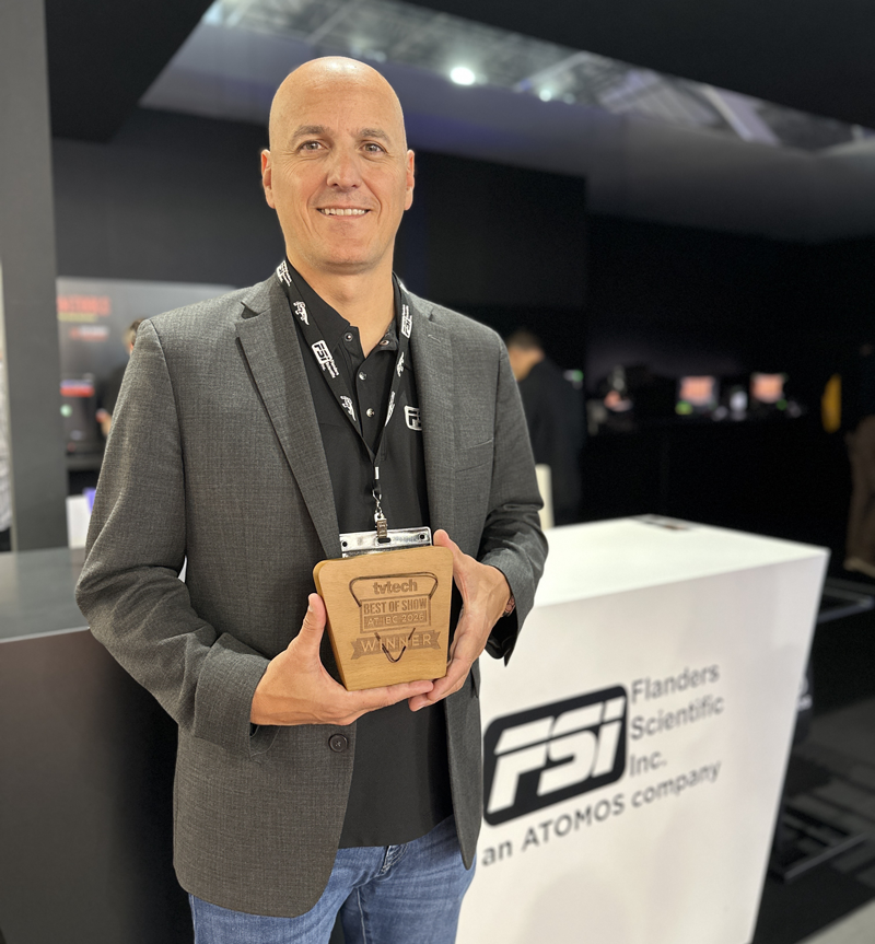 Bram Desmet, Managing Director of FSI, holds the Best of Show Award for the GaiaColor AutoCal/Analyzer system